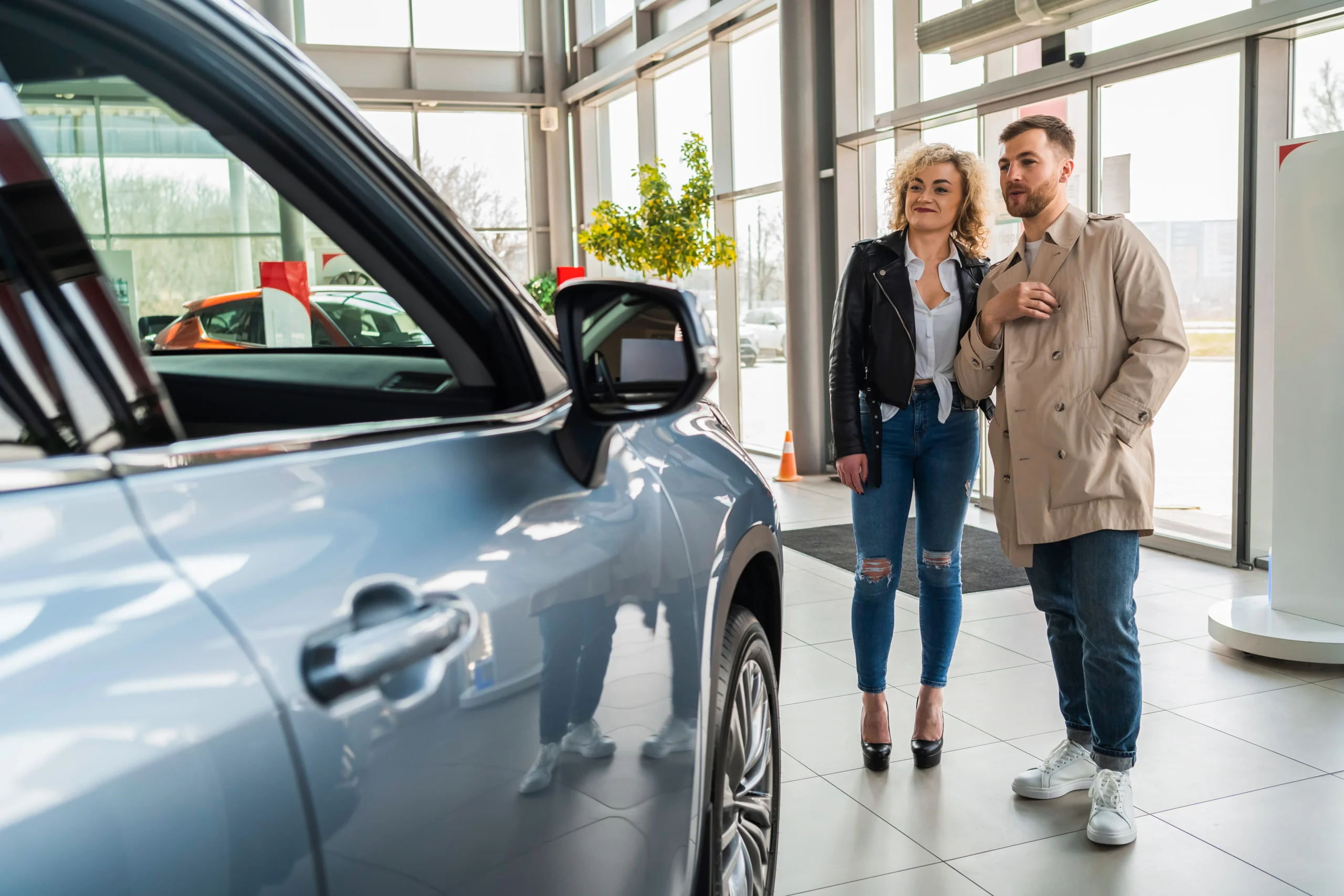 beautiful-couple-in-car-dealership-chooses-car-